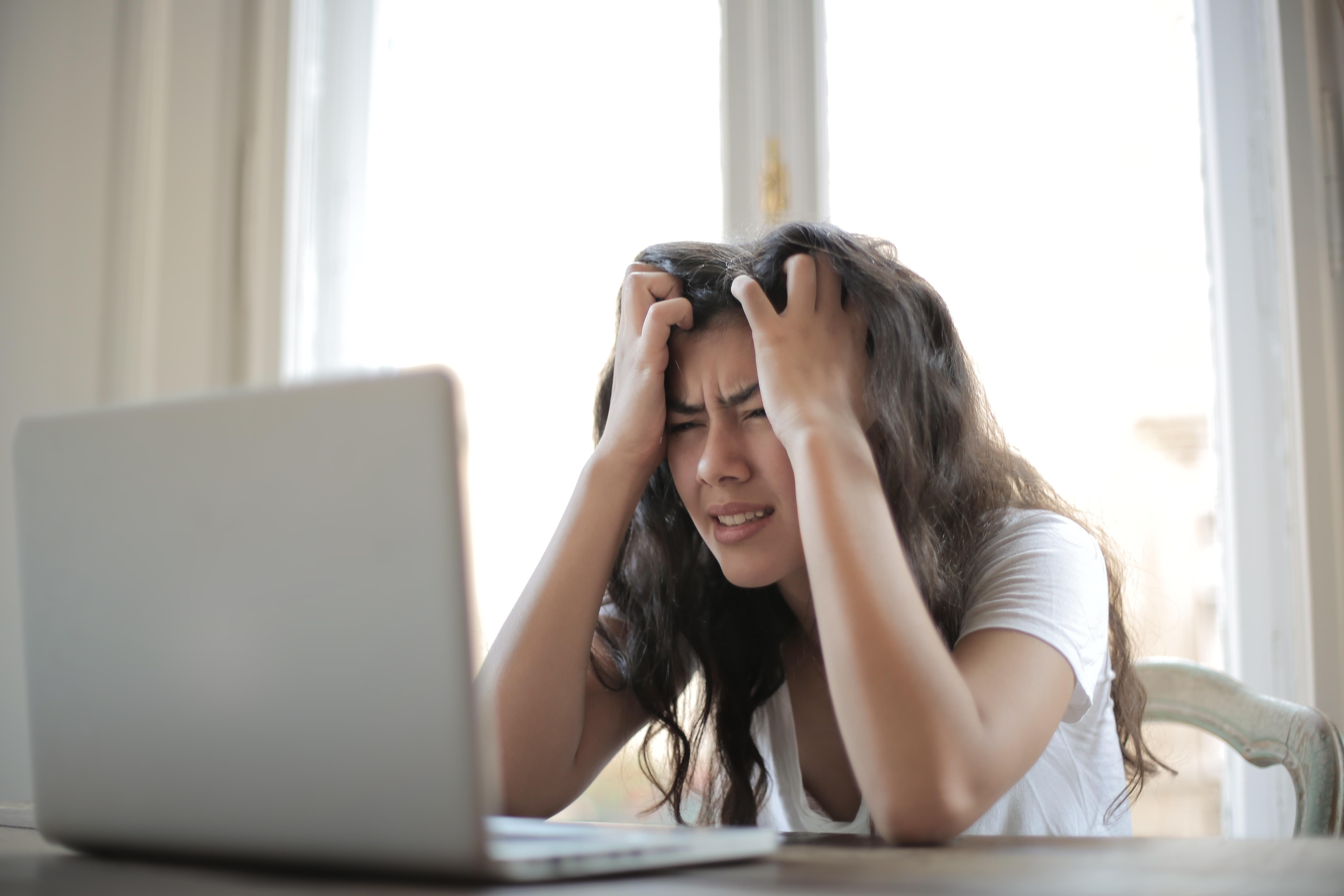 A woman pulling her hair out in frustration regarding real estate tech.