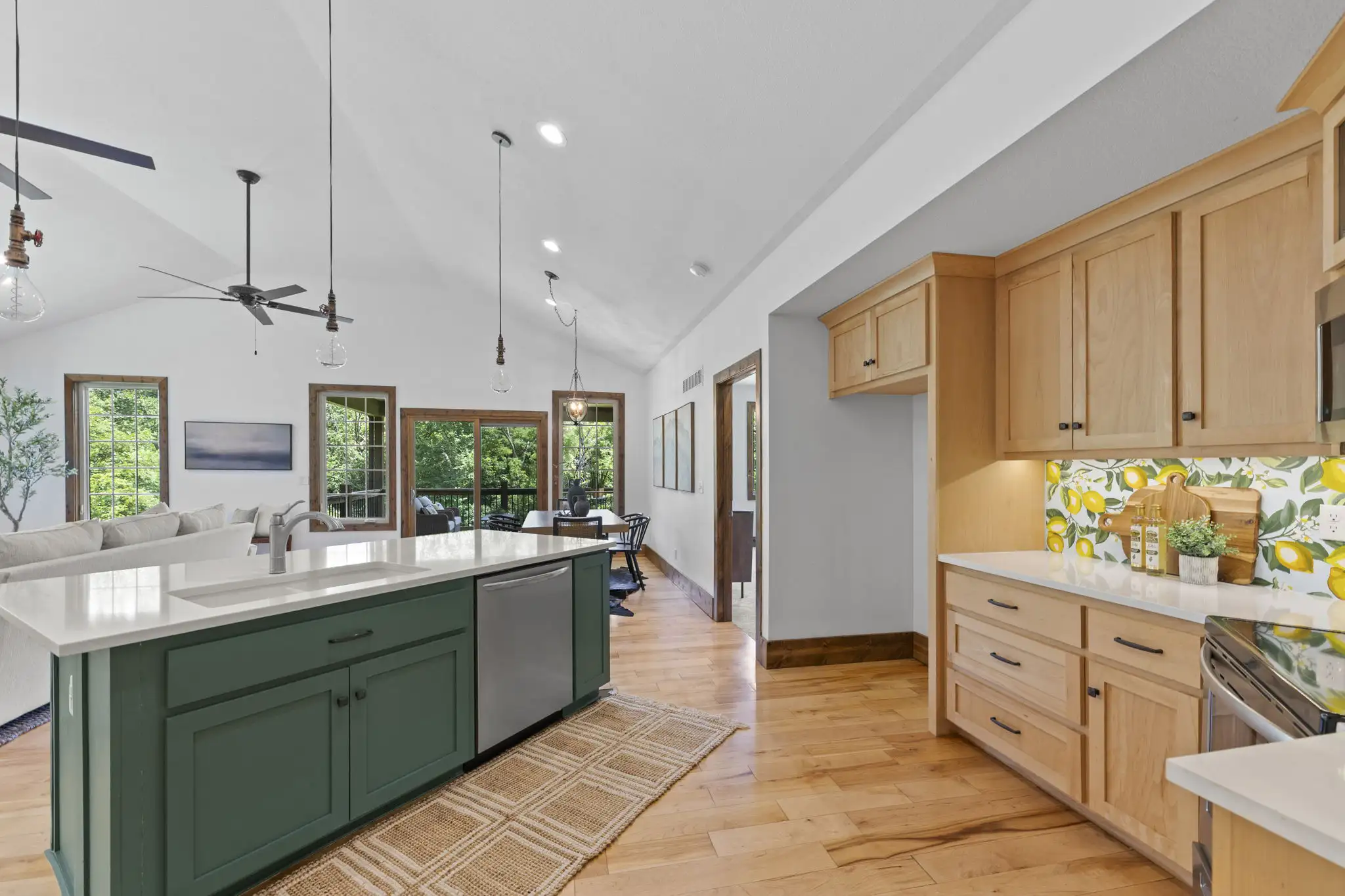 Kitchen with large island, stained cabinetry, and walk-in pantry.