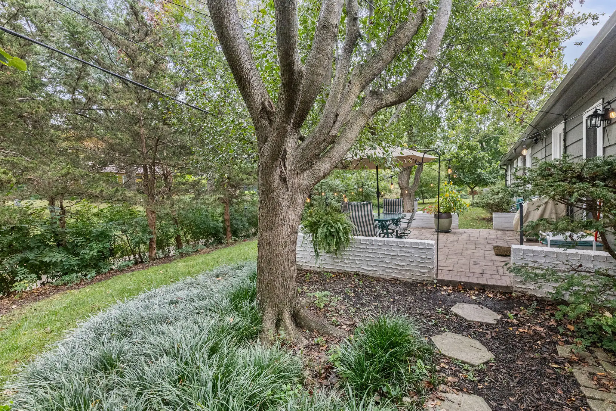 Side yard garden path leading to the paver patio