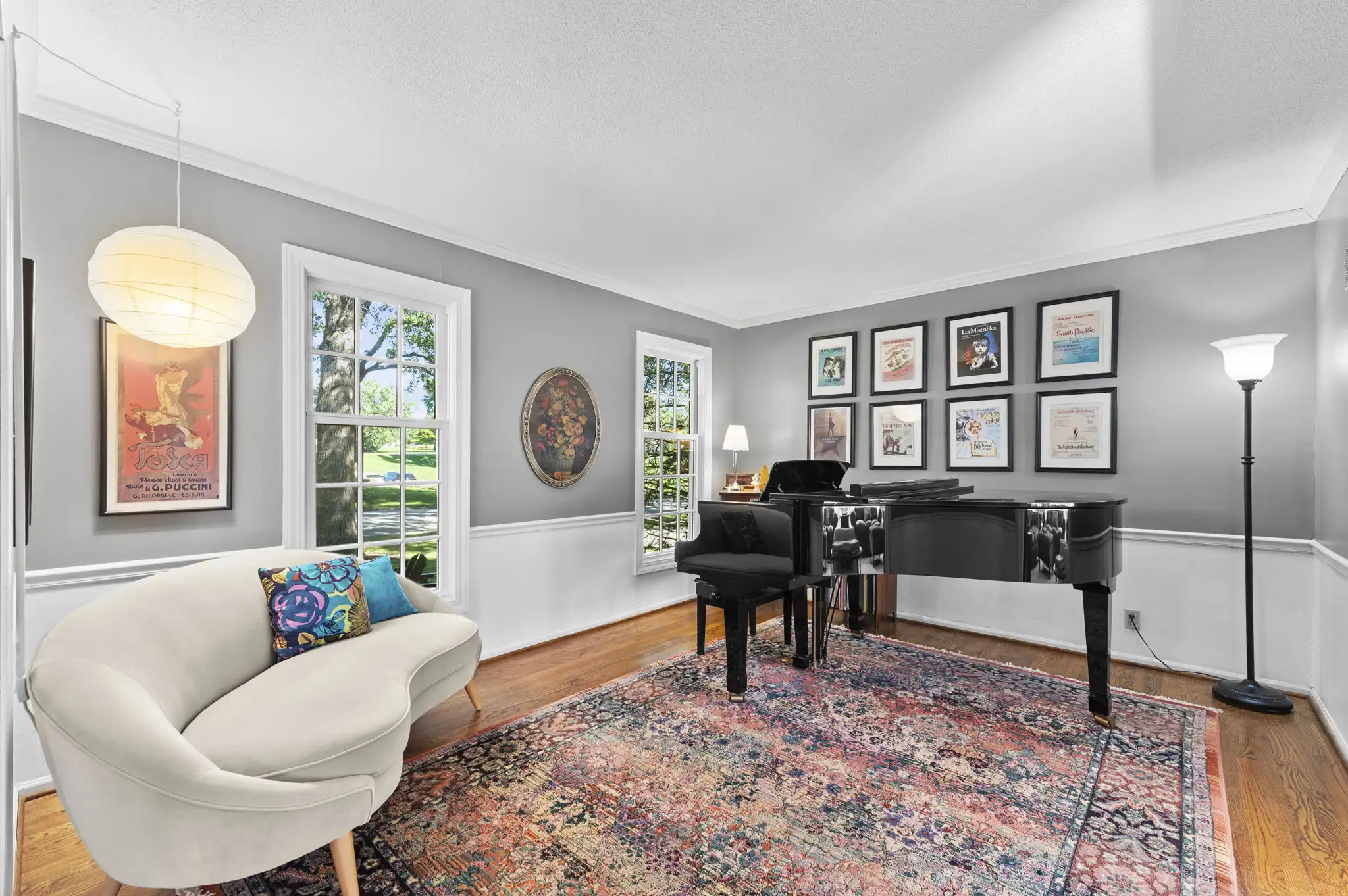 Formal living room with hardwood floors, chair rail and tall front windows