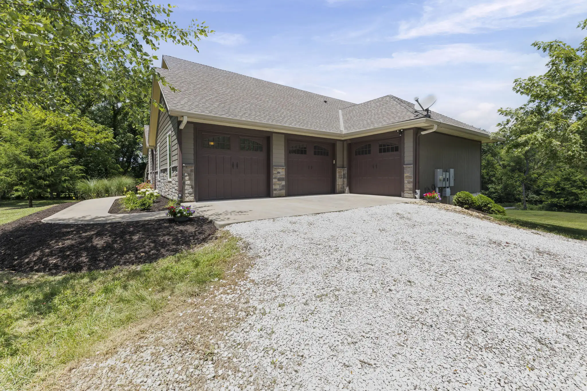 3-car attached garage with carriage-style doors.