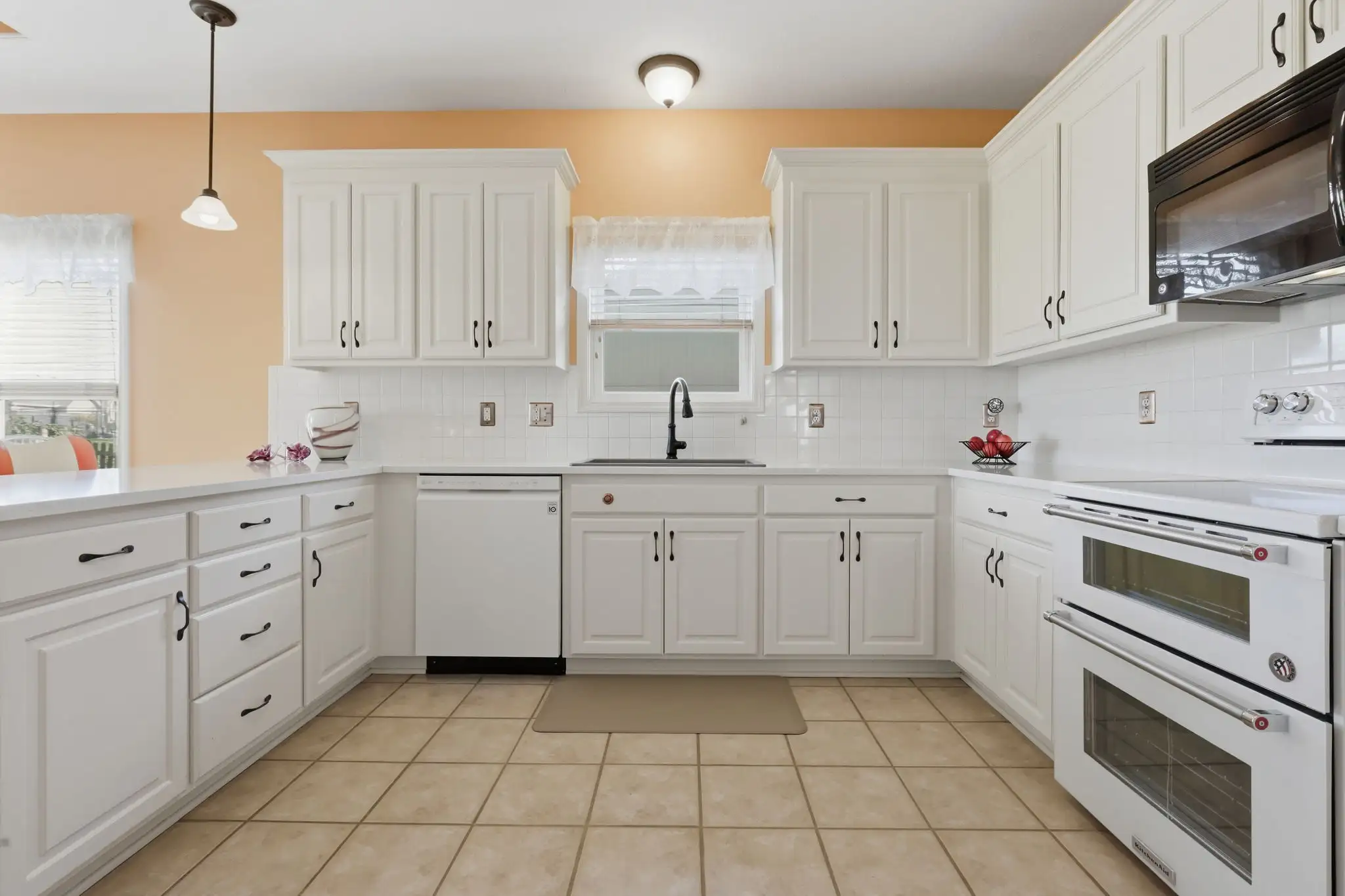 Kitchen peninsula with quartz counters and bar seating