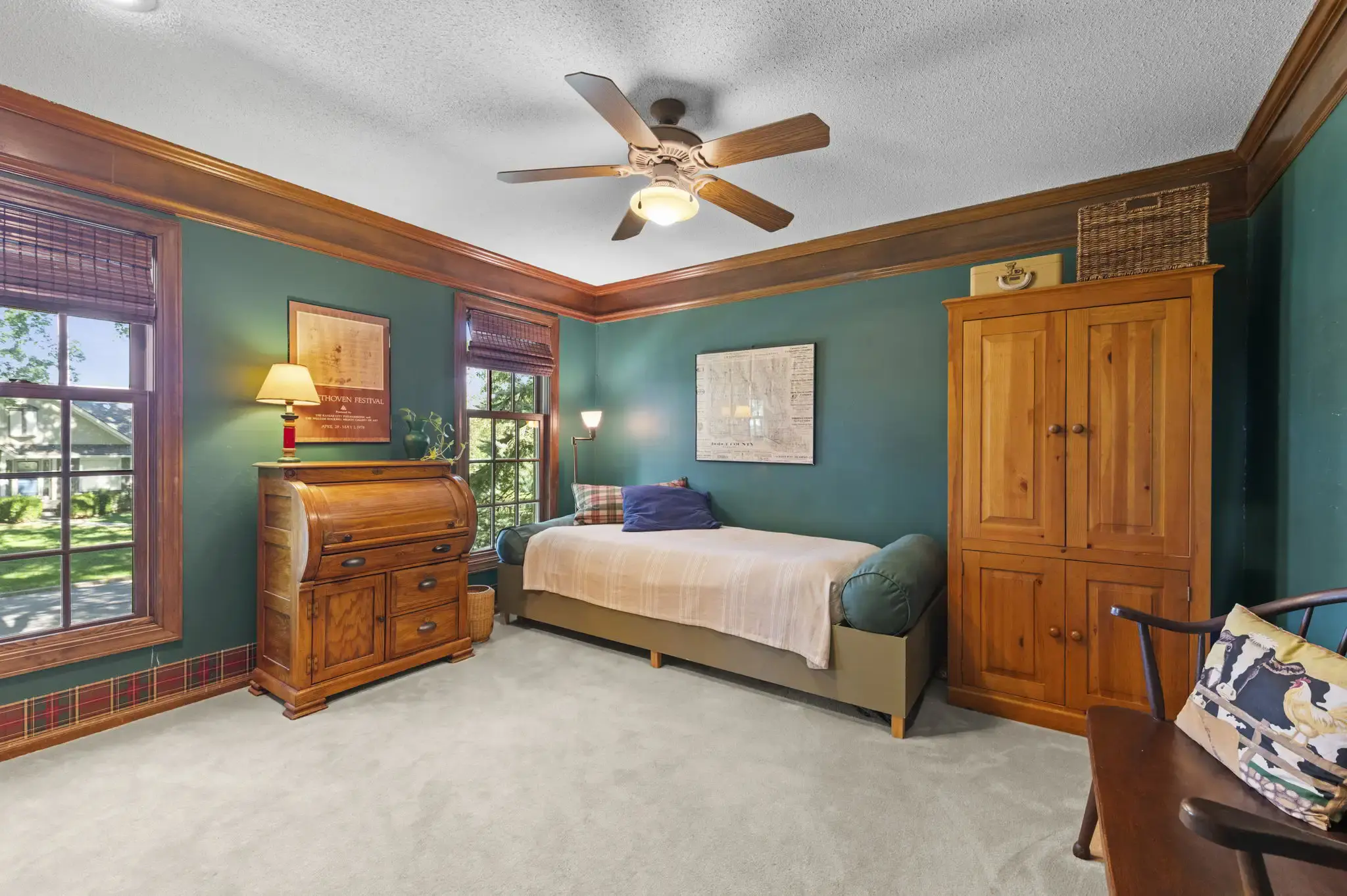 Bedroom with wood crown molding, ceiling fan and two windows