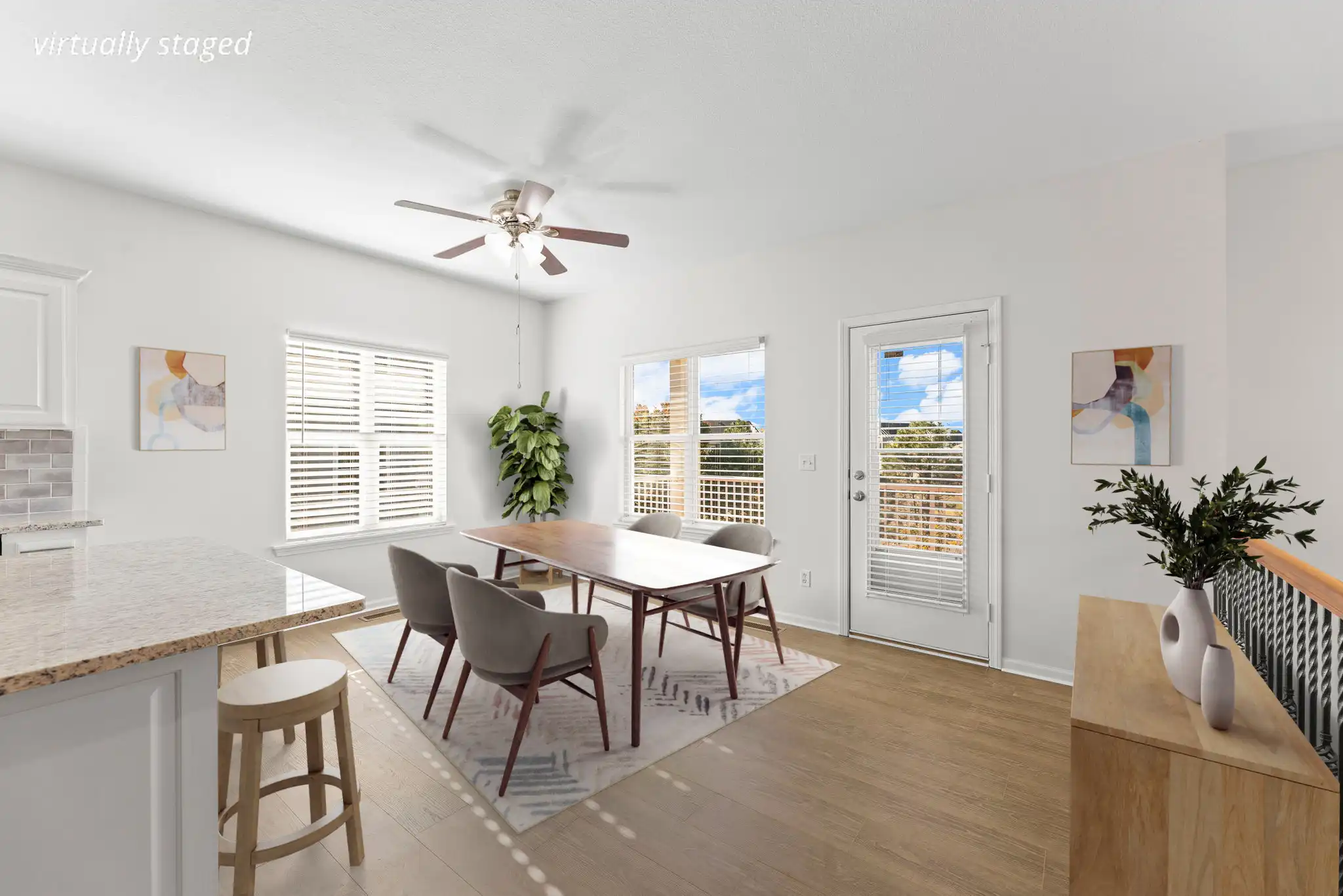 Breakfast room at 21962 W 116th Terrace Olathe KS — light-filled dining space with windows, ceiling fan, and wood floors.