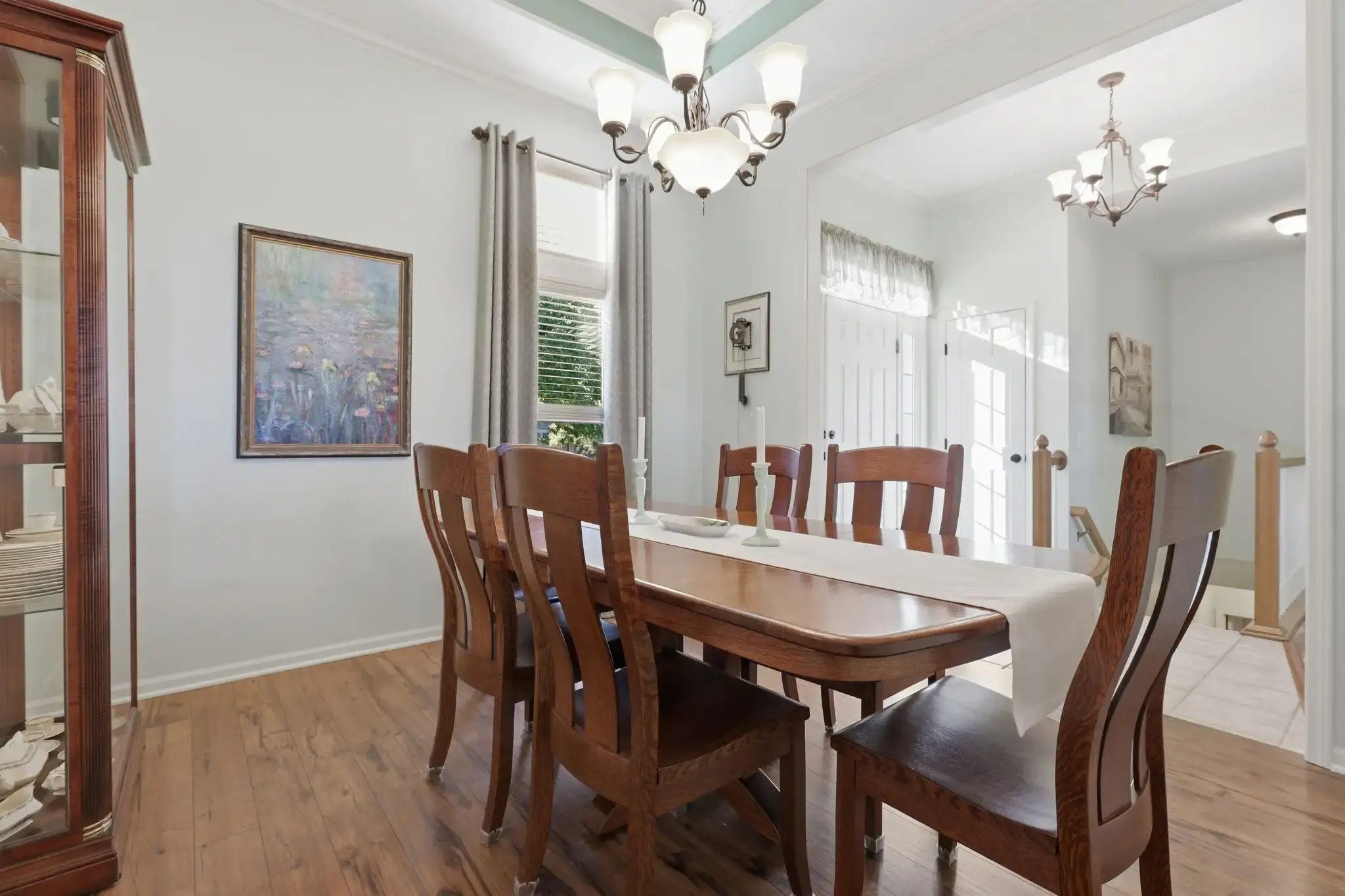 Formal dining room with tray ceiling and chandelier