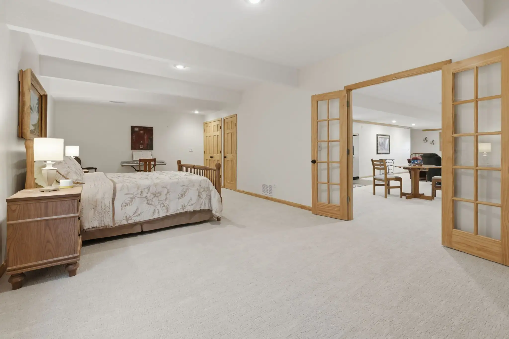 Lower-level bedroom with French doors to the family room