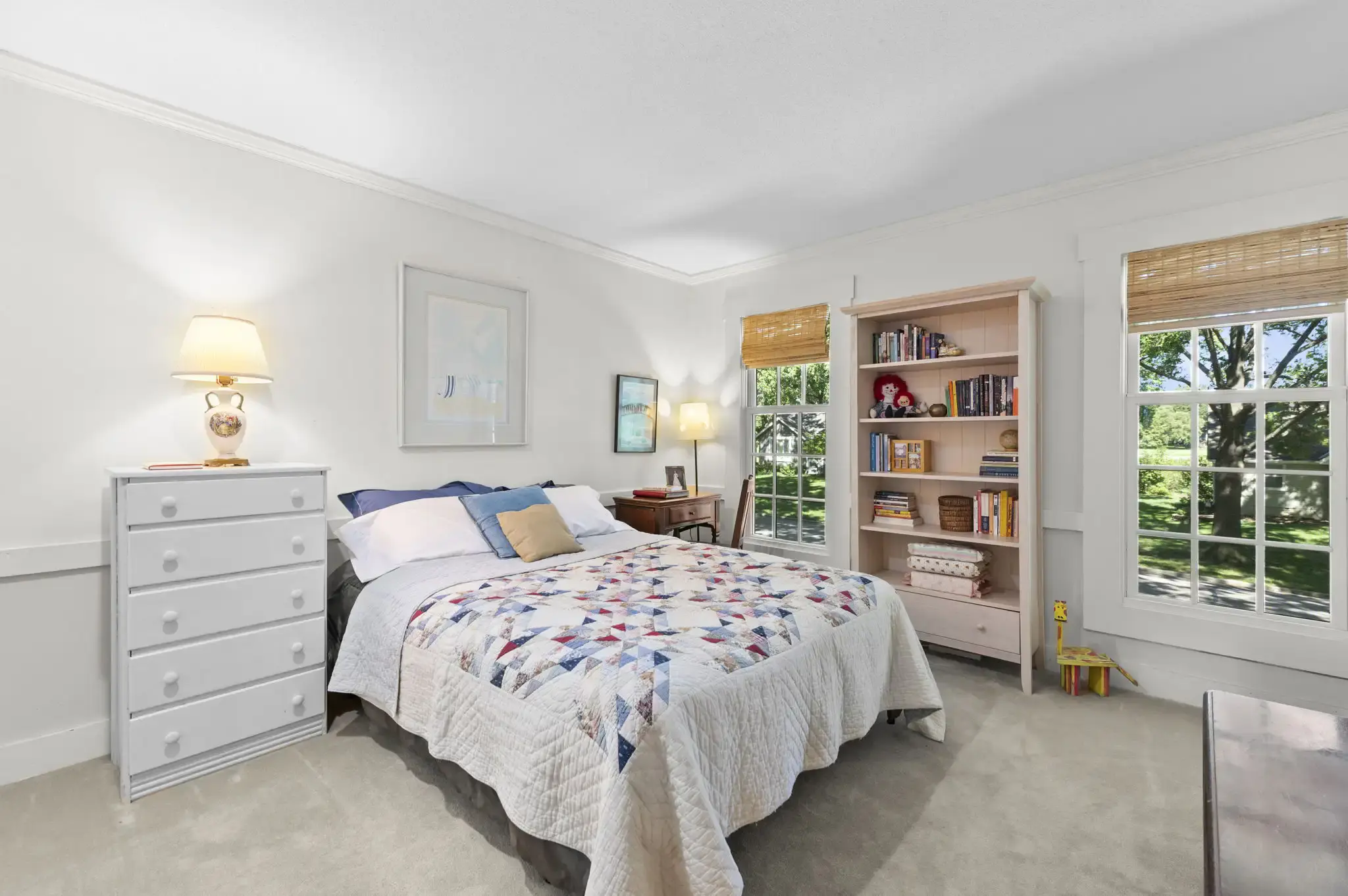 Bright bedroom with two windows and crown molding