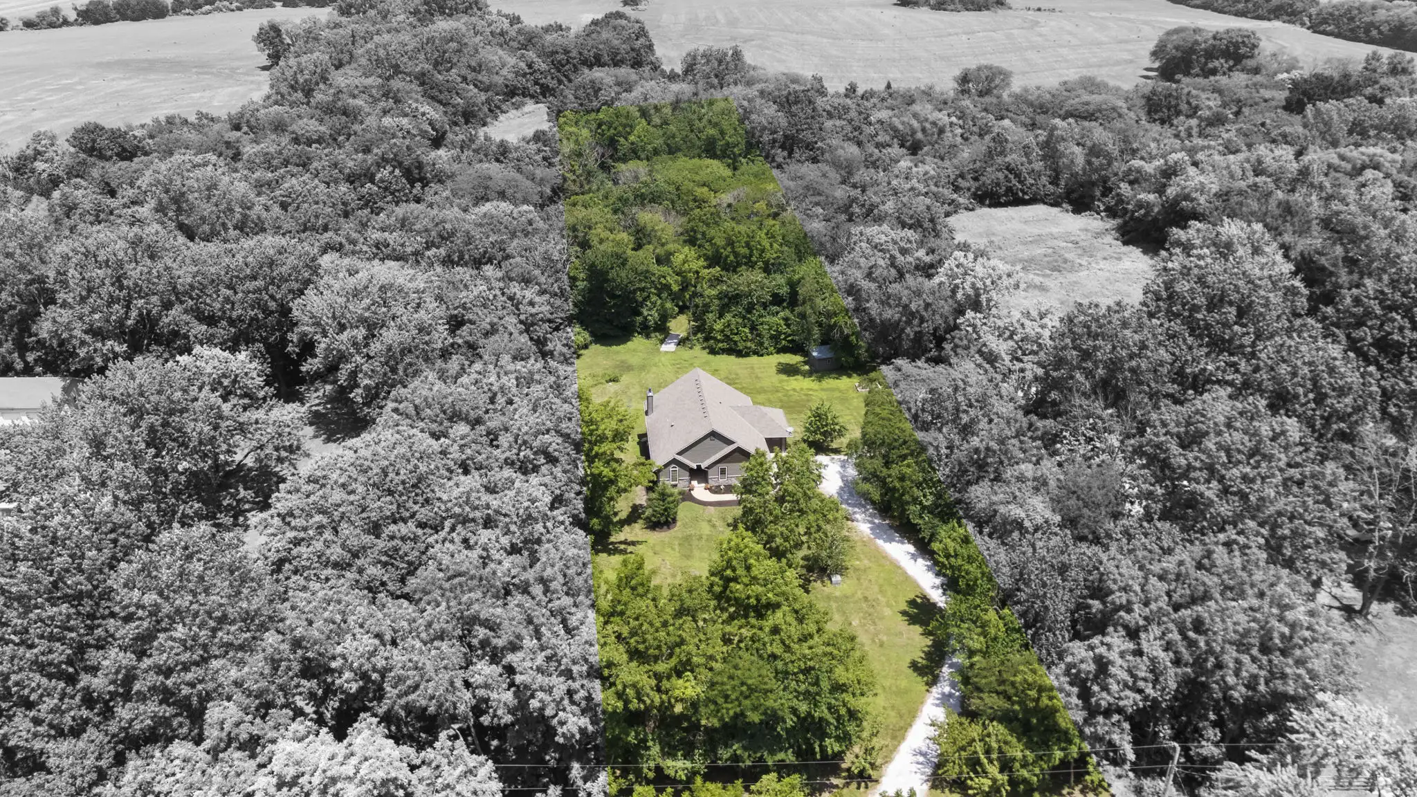 Aerial view of the 4.9-acre parcel boundary and wooded surroundings.