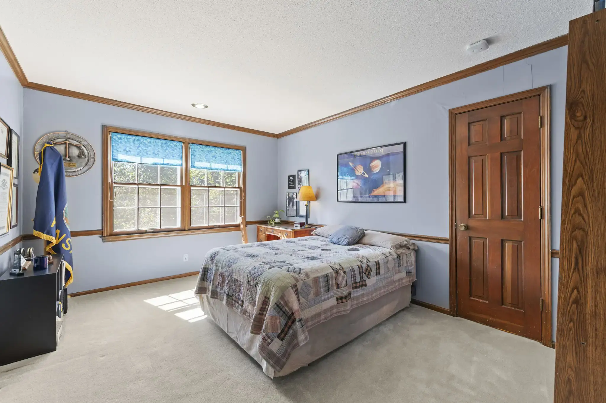Bedroom with crown molding, chair rail and double window
