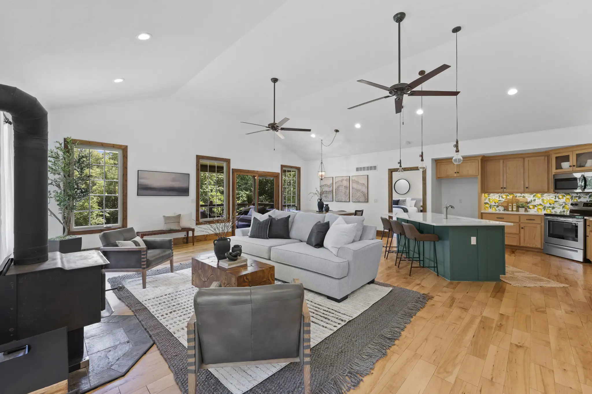 Vaulted great room with wood-burning fireplace and maple hardwood floors.