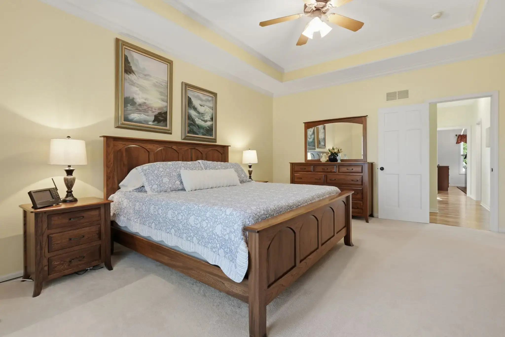 Primary bedroom with dresser and door to the hallway