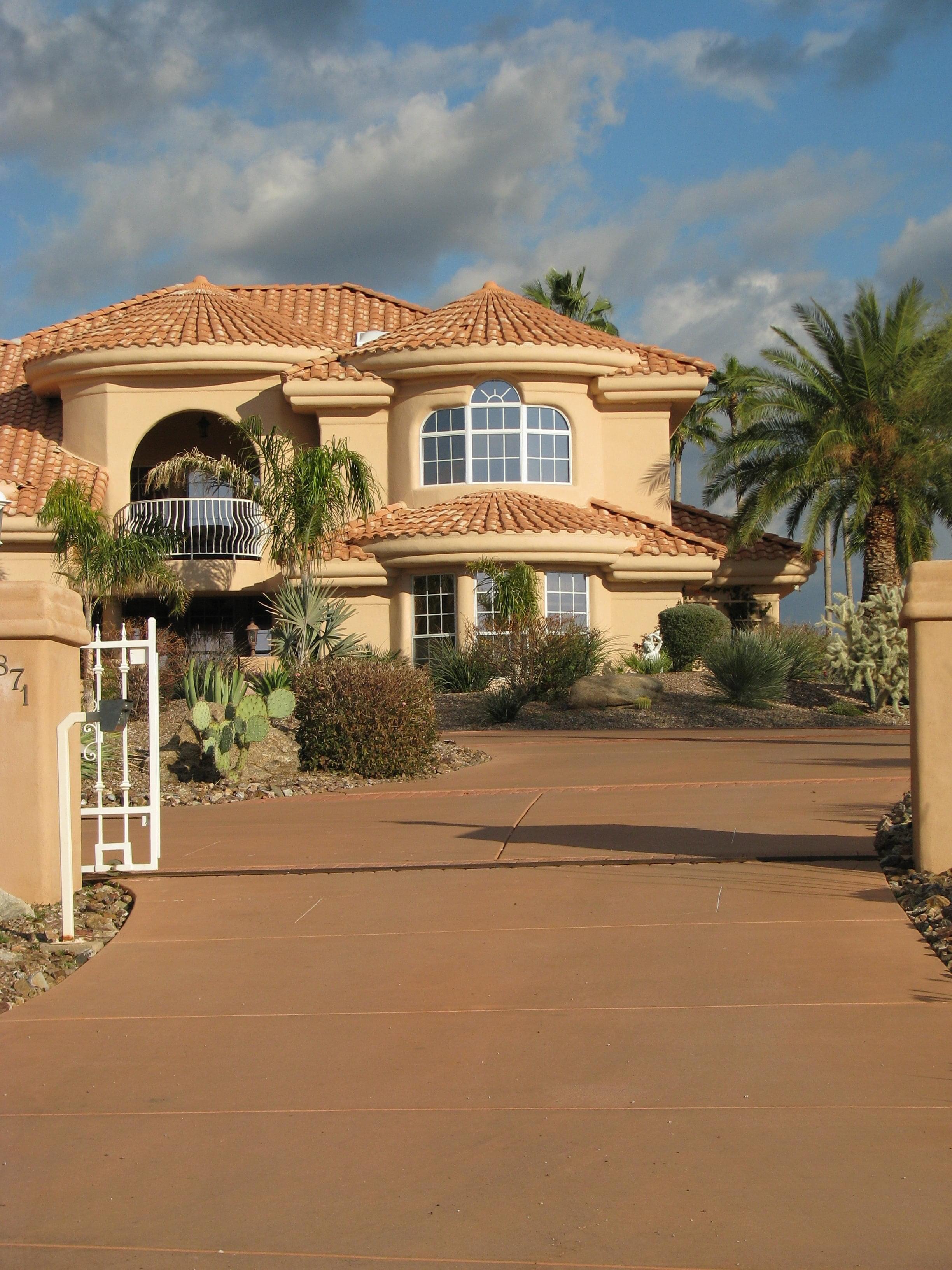 A Tuscan-style home with many palm trees