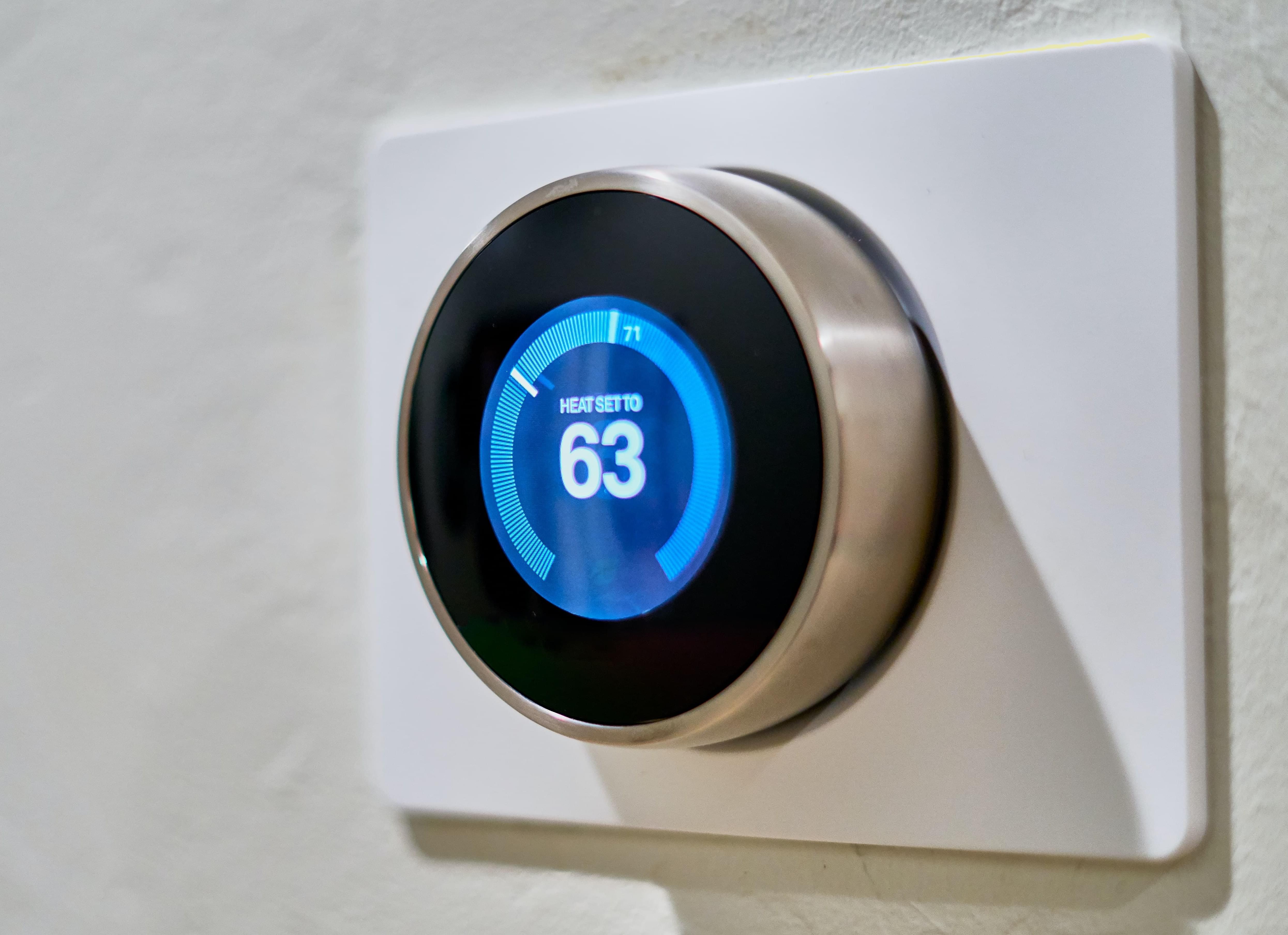 A smart thermostat set to 63