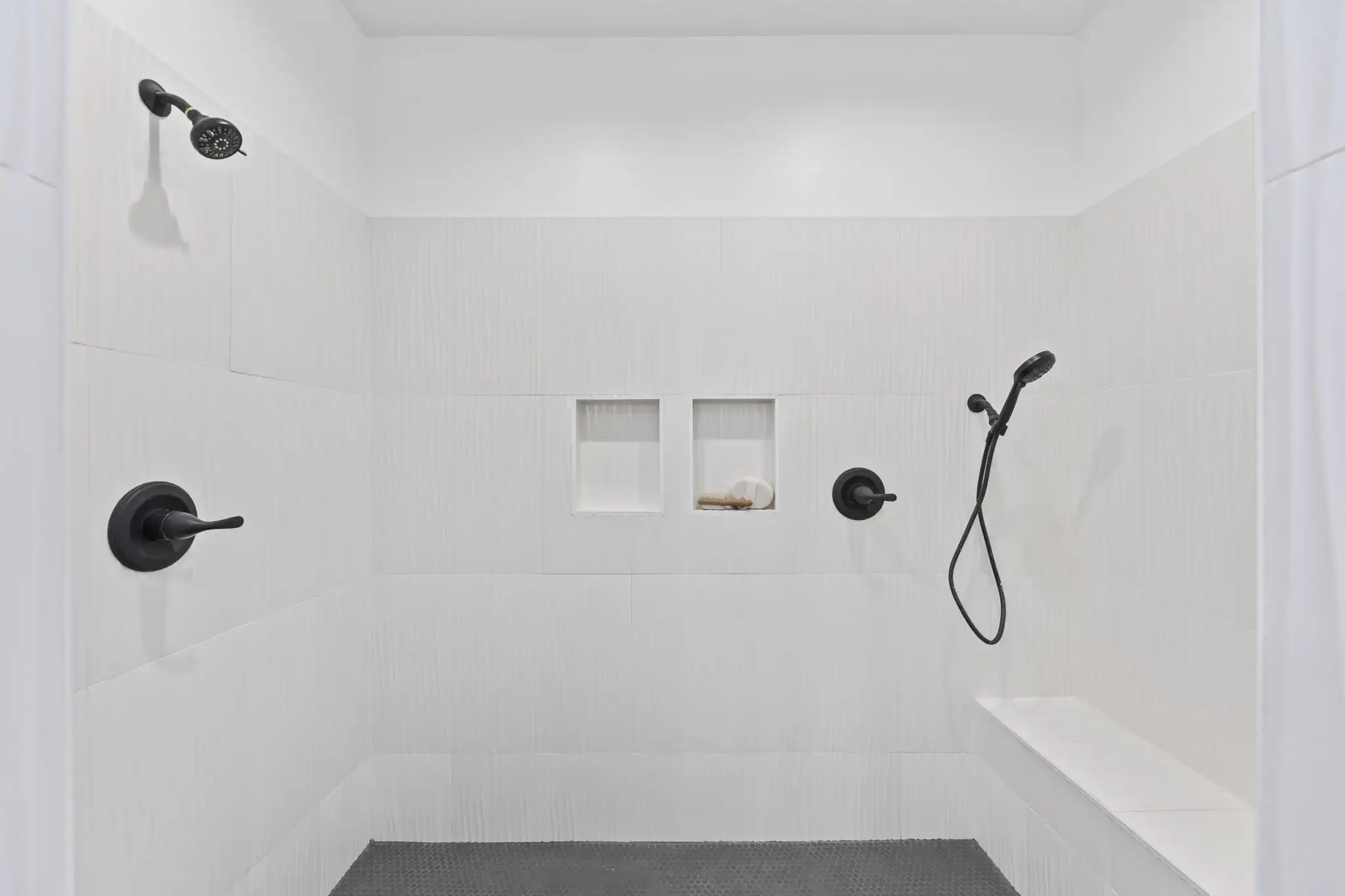 Primary bathroom zero-entry shower with tile surround.