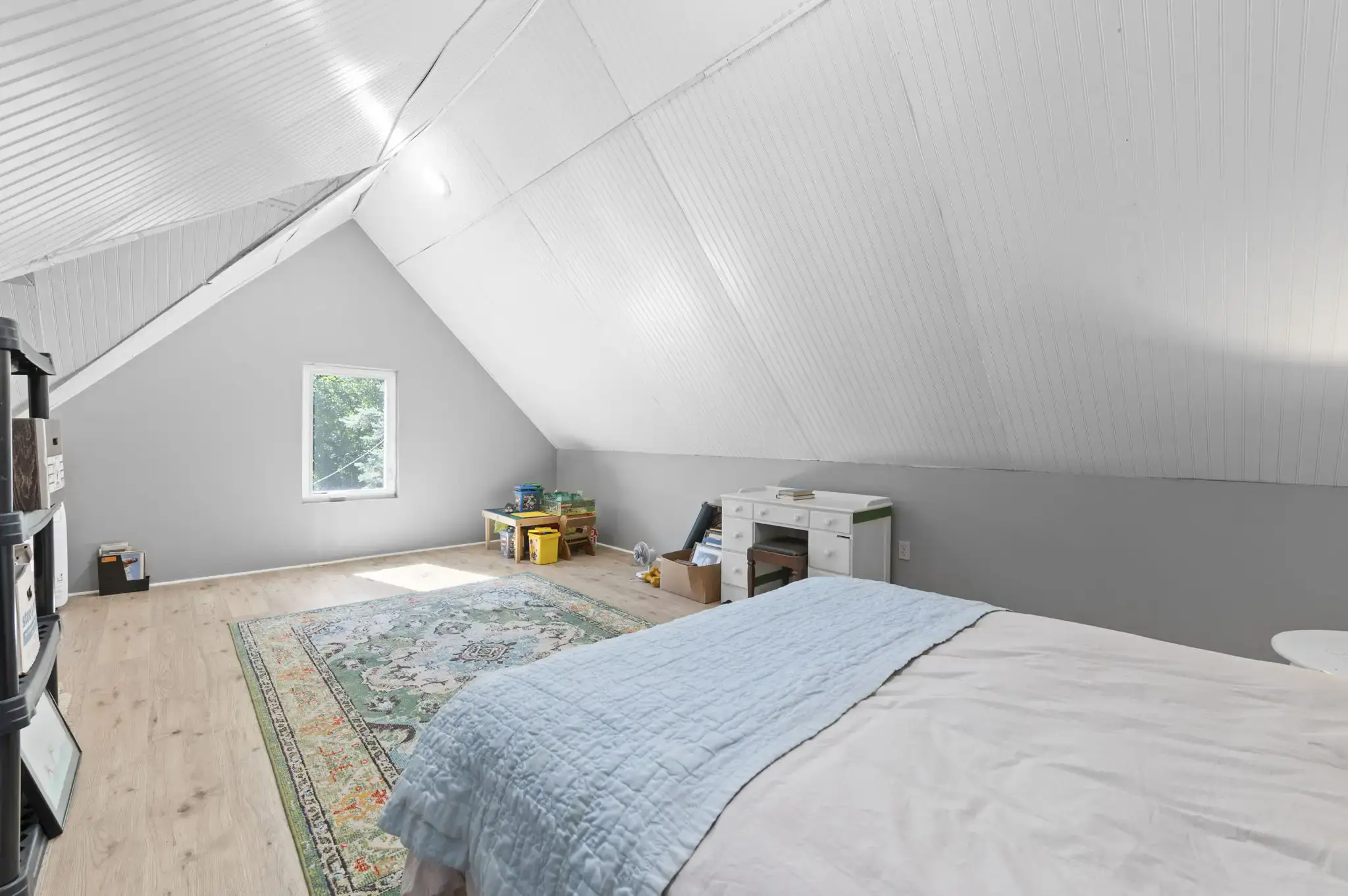 Bonus room with sloped ceiling and window for natural light