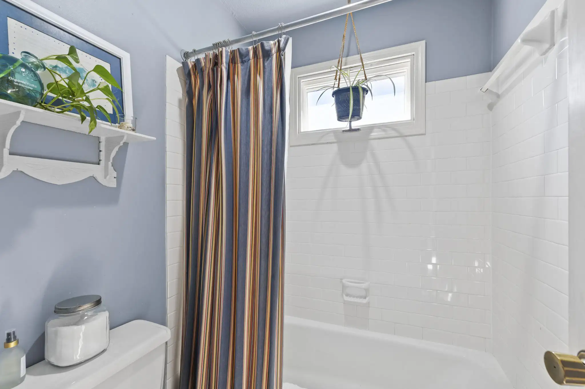 Full bath with tub-shower and white subway tile surround