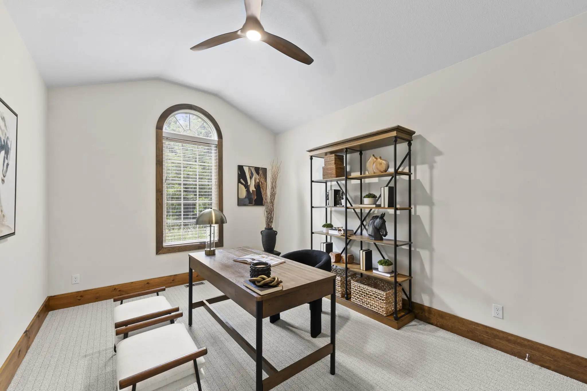 Secondary bedroom with vaulted ceiling and arched window.