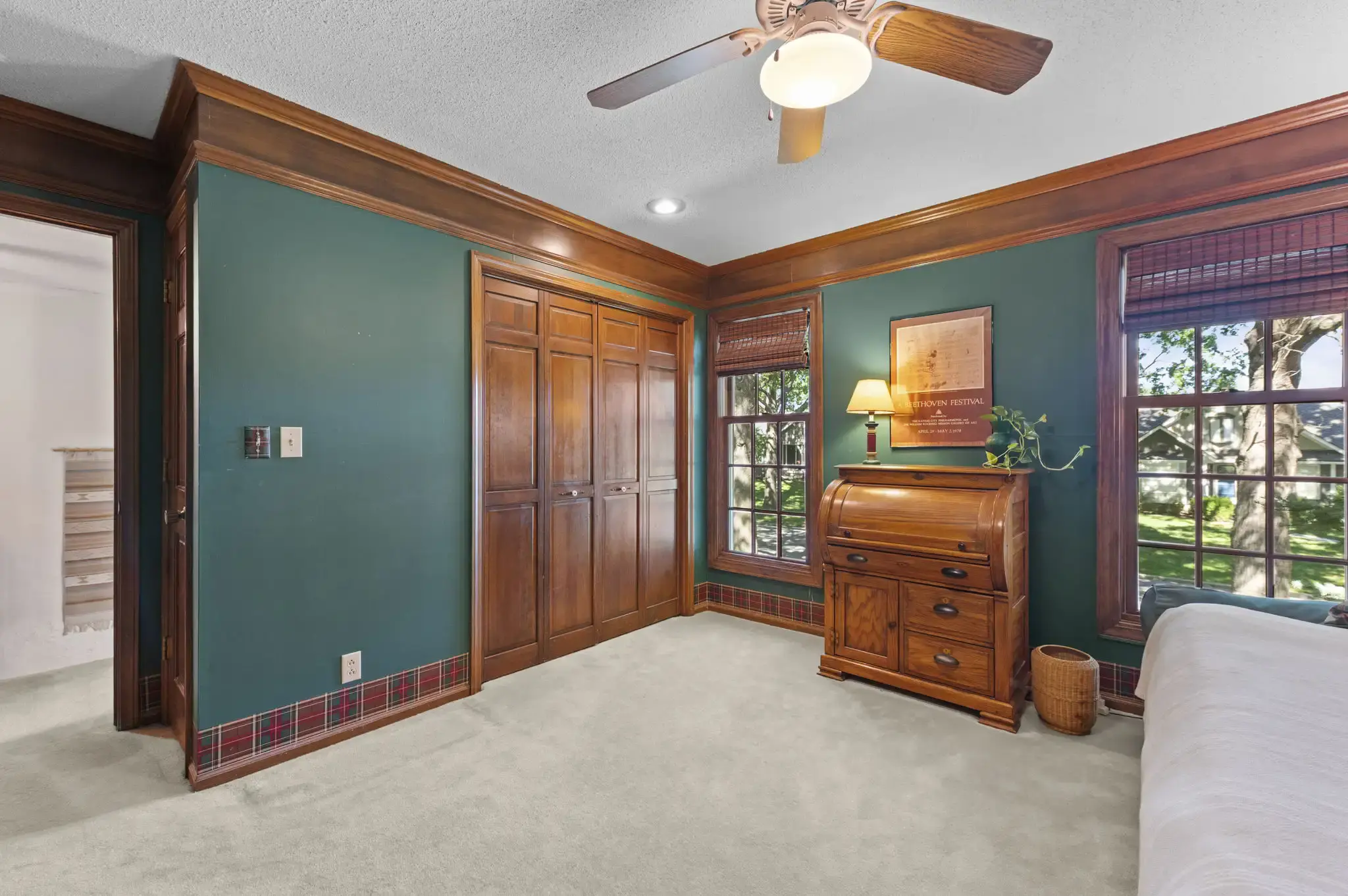 Bedroom with built-in wood closet doors and crown molding