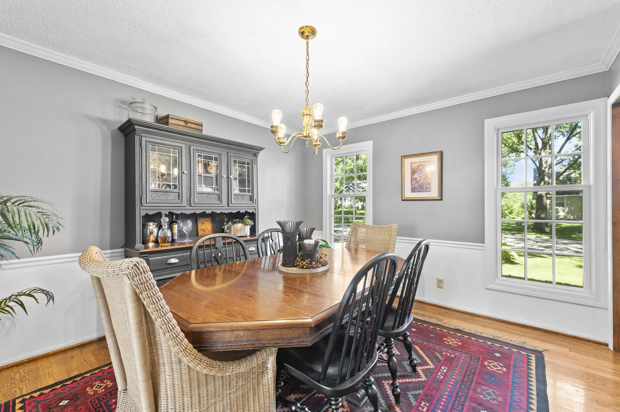Formal dining room with chandelier, chair rail and hardwood floors