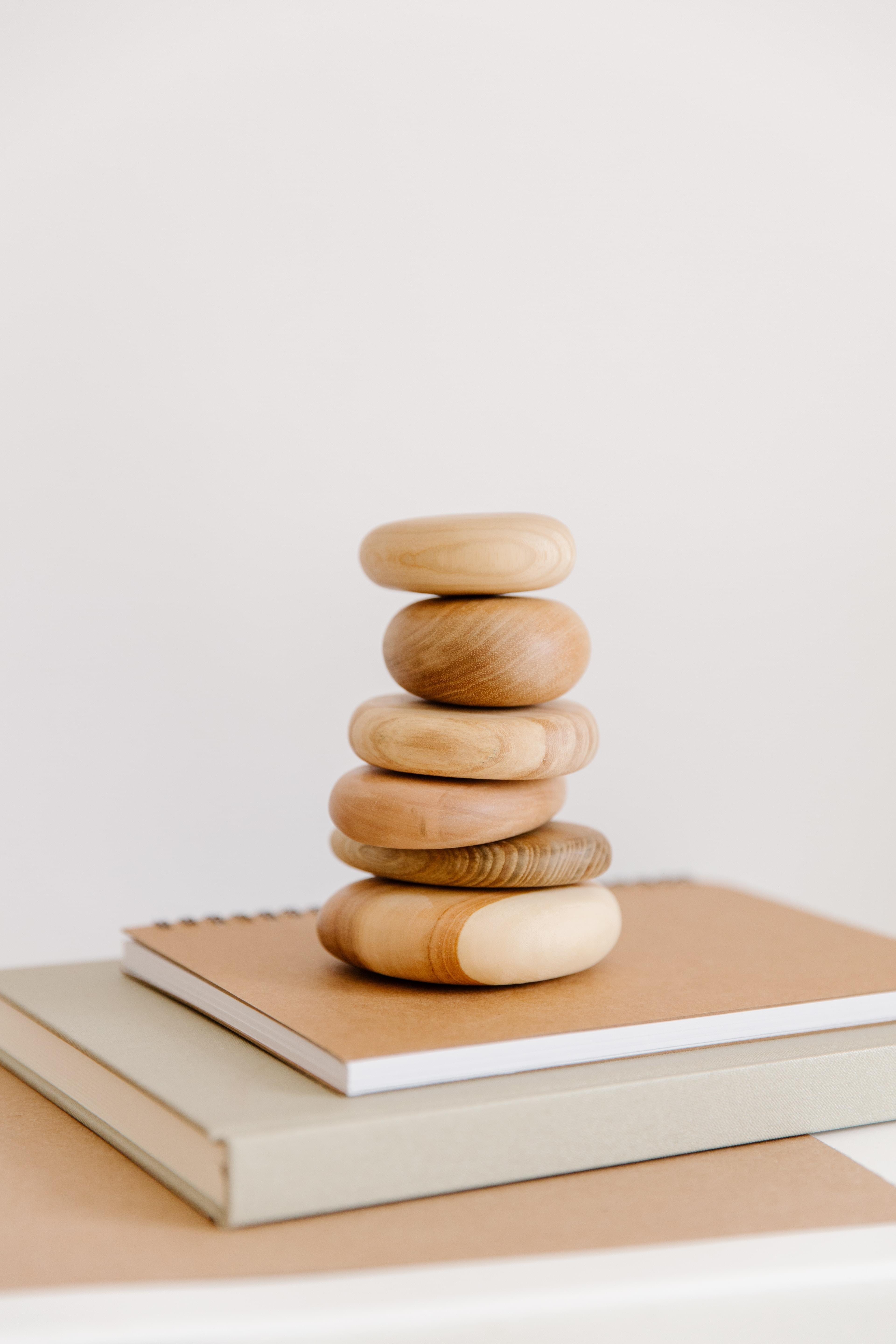 A stack of woodgrain stones balanced in a pyramid shape to create stability