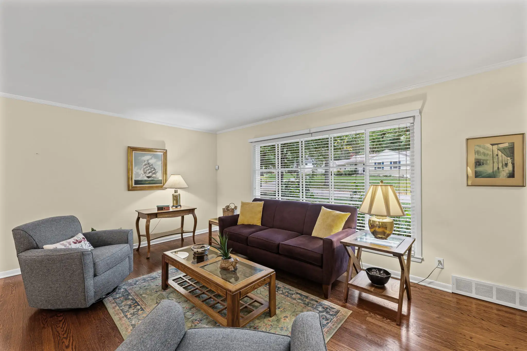 Living room with hardwood floors and a large picture window