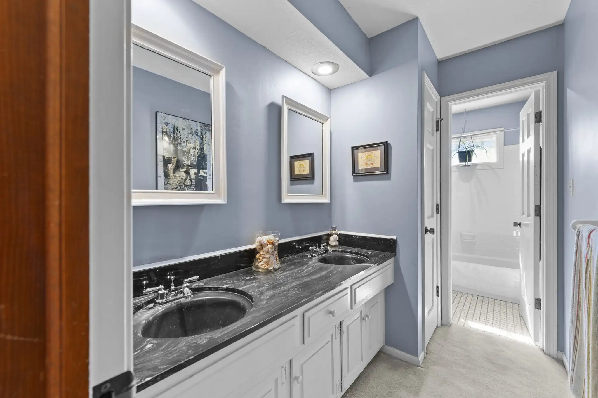 Full bath with double vanity and separate tub and toilet room