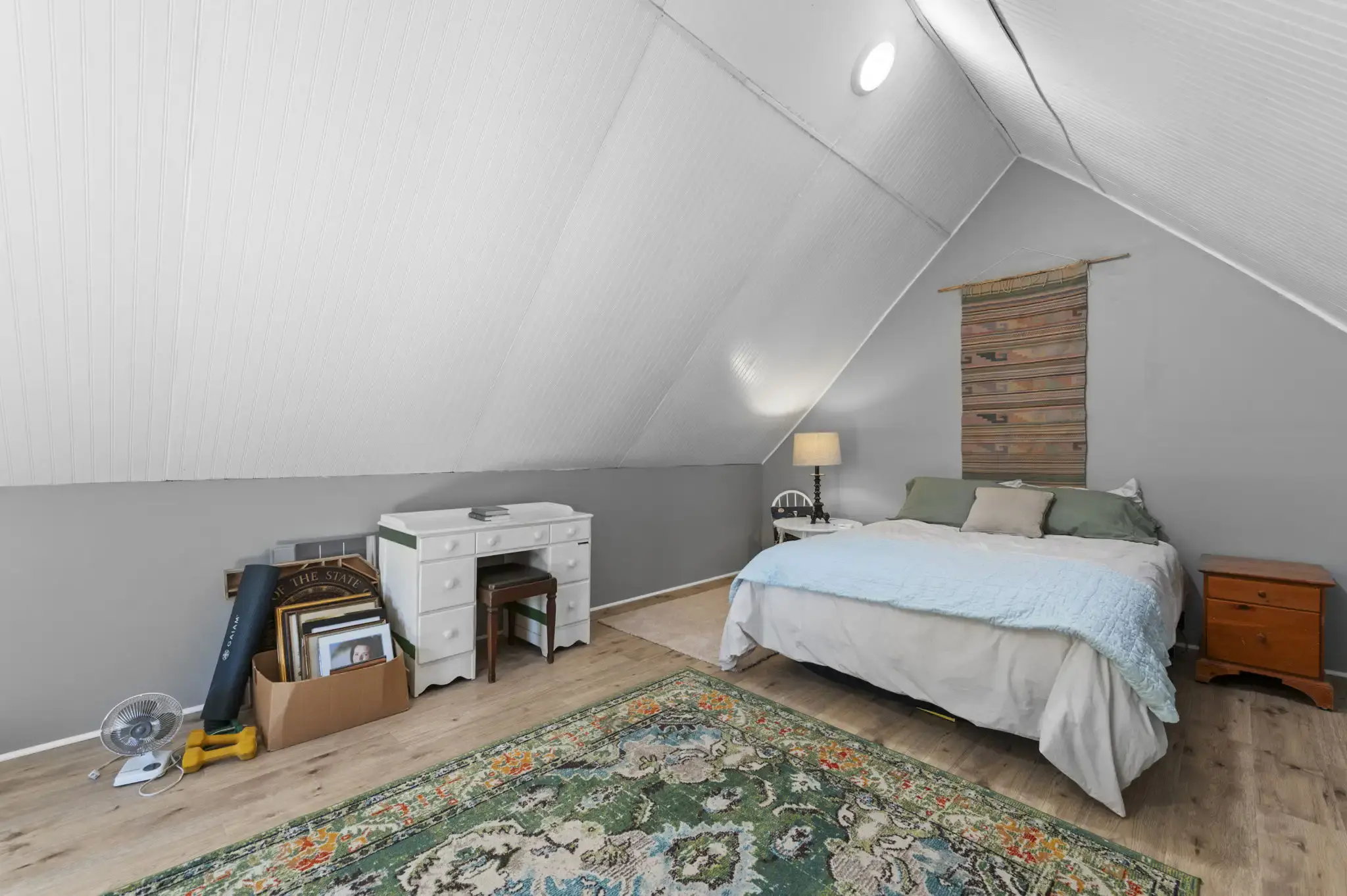 Bonus room with vaulted beadboard ceiling and light wood-look floors