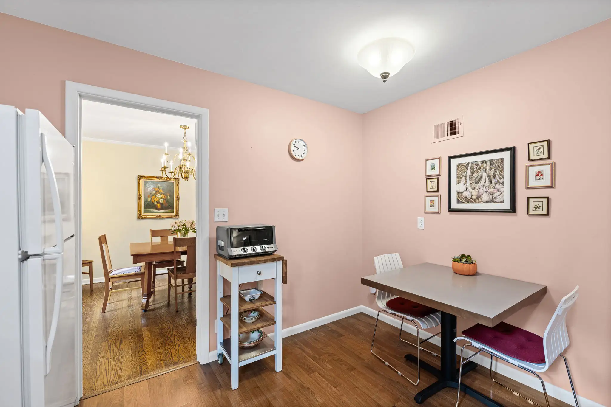 Eat-in kitchen with a breakfast table and a doorway to the dining room