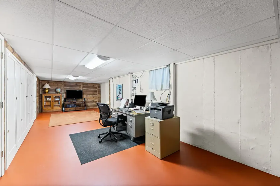 Lower level with an office area, storage closets and a rec room