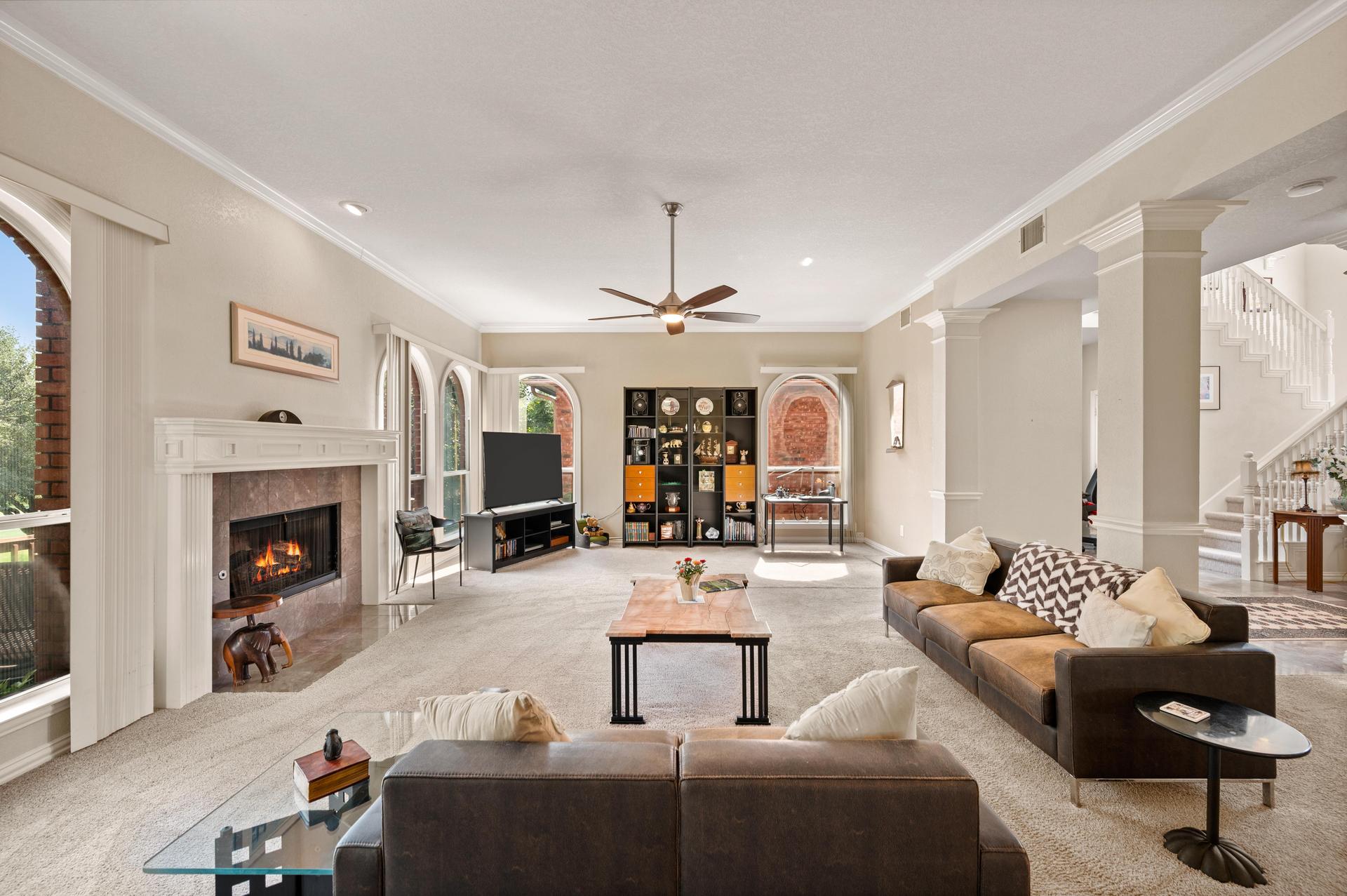 Open-concept living room with fireplace and kitchen area at 7626 Lakecrest Circle
