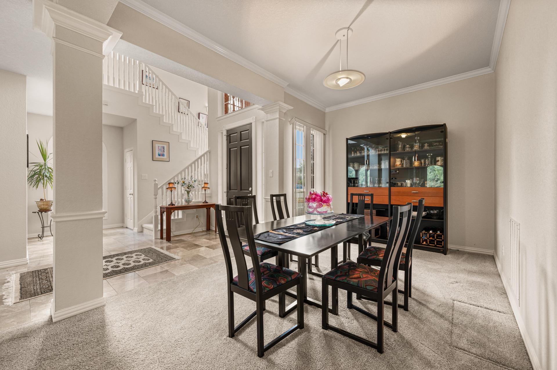 Formal dining room with large dining table and built-in display cabinet at 7626 Lakecrest Circle