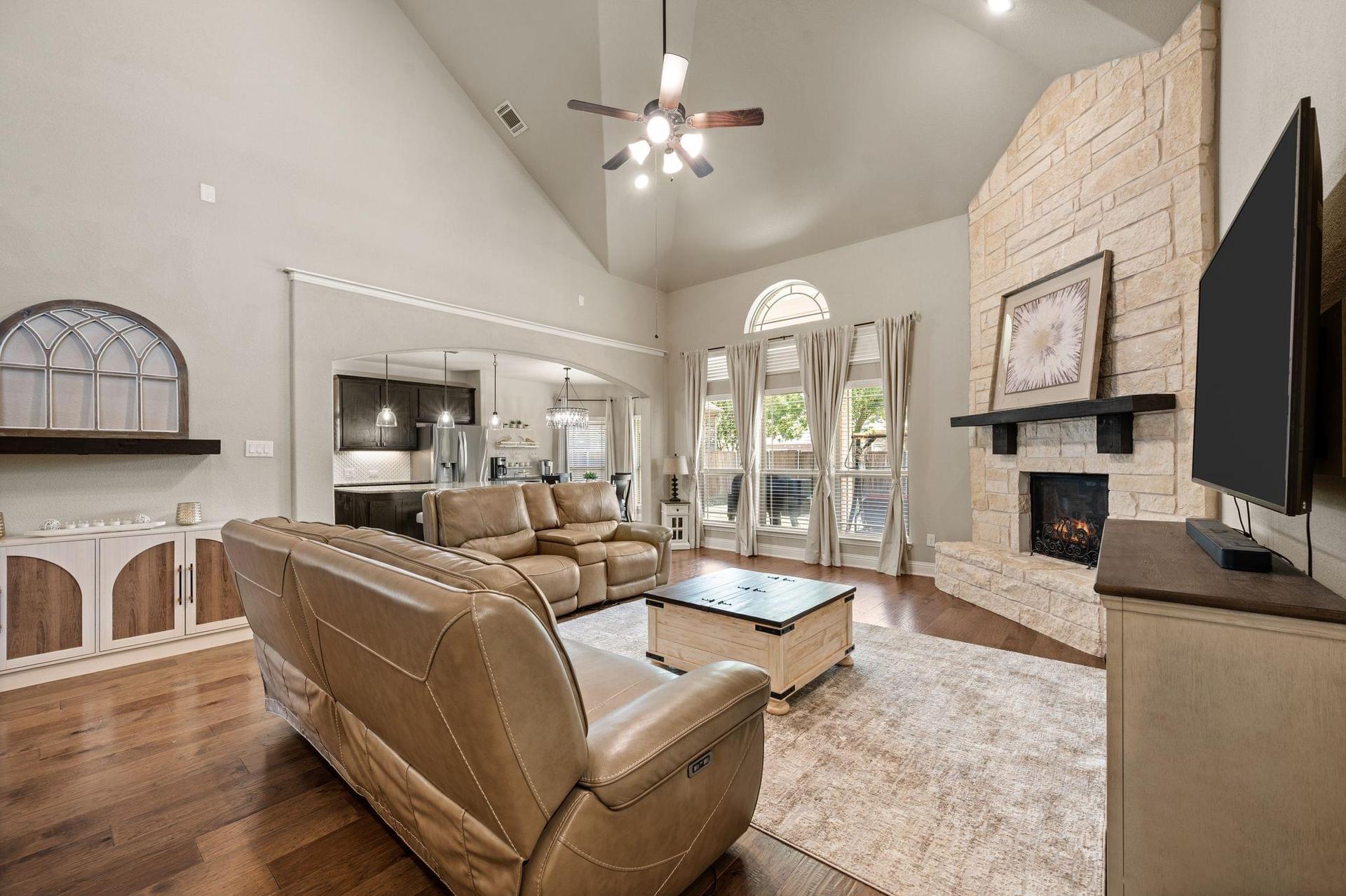 Family room with hardwood floors and fireplace at 4201 Rainwater Creek Way in Celina, Texas