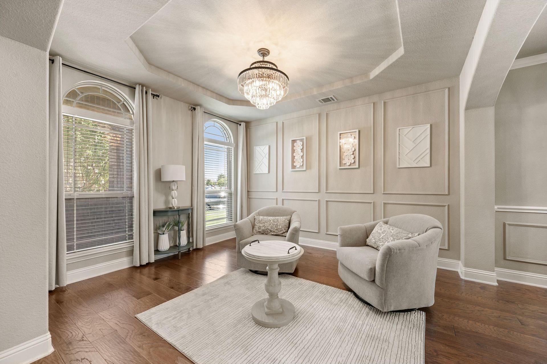 Living room with hardwood floors and fireplace at 4201 Rainwater Creek Way in Celina, Texas