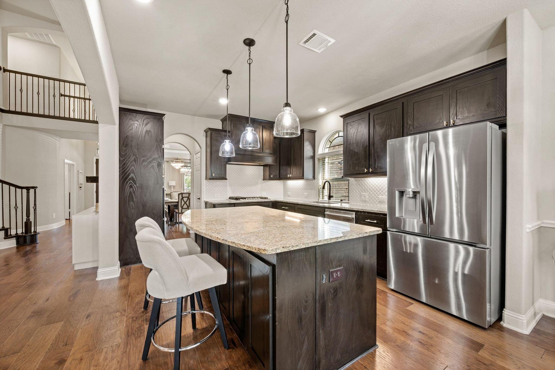 Kitchen with wide center island at 4201 Rainwater Creek Way in Celina, Texas