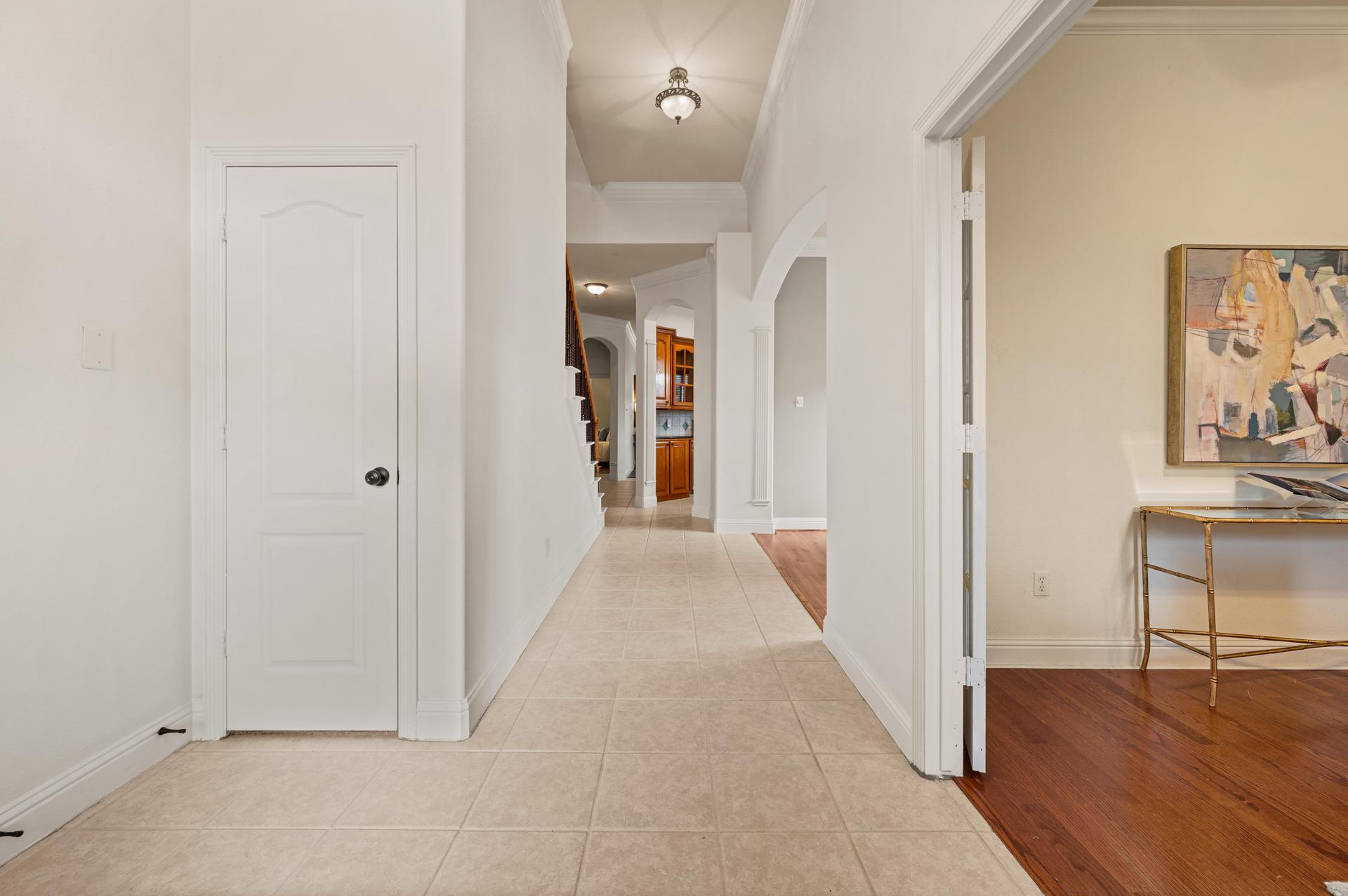 Spacious entry with elegant arched openings and views of the kitchen and adjoining living spaces