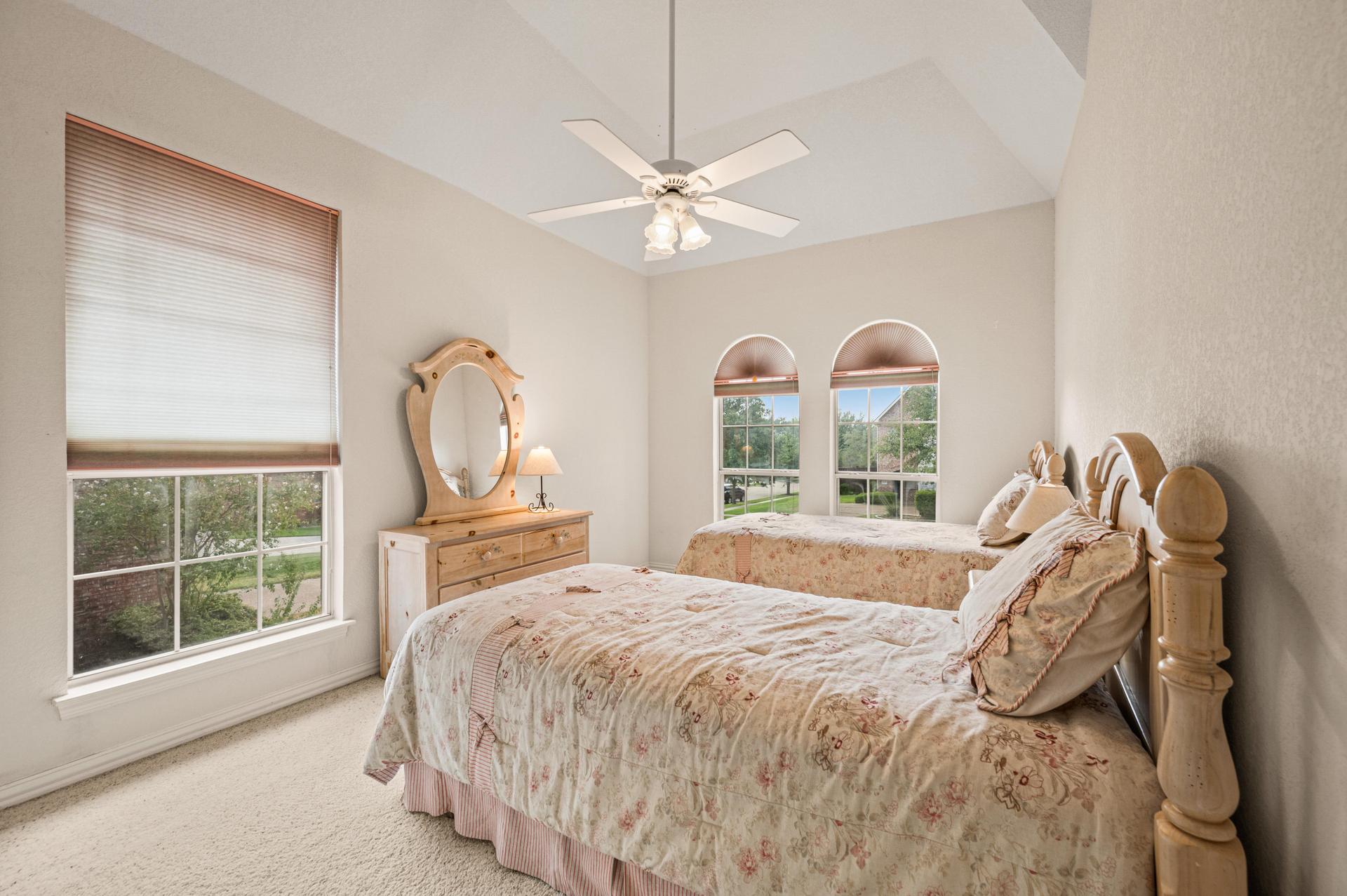 Second bedroom with carpeted flooring and ceiling fan at 7626 Lakecrest Circle