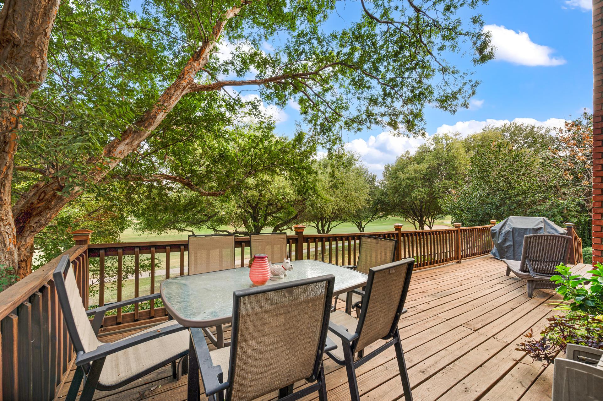 Deck with outdoor seating overlooking the golf course at 7626 Lakecrest Circle