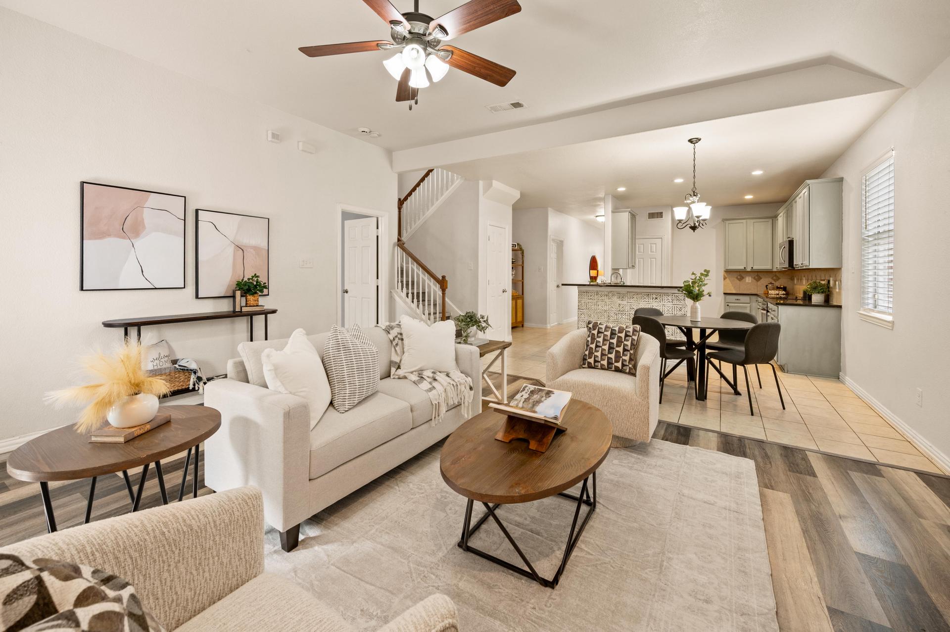 Living room’s view of the open-concept layout with decorative fireplace.