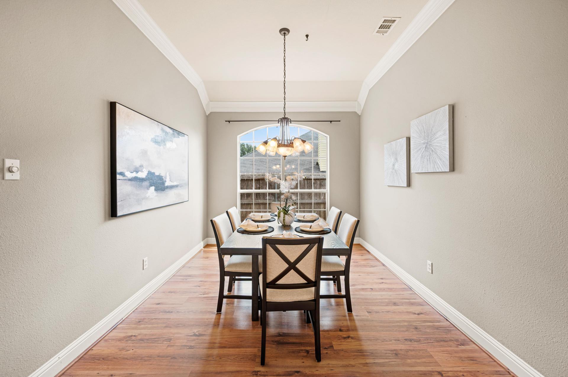 Formal dining room with elegant arched windows that fill the space with natural light