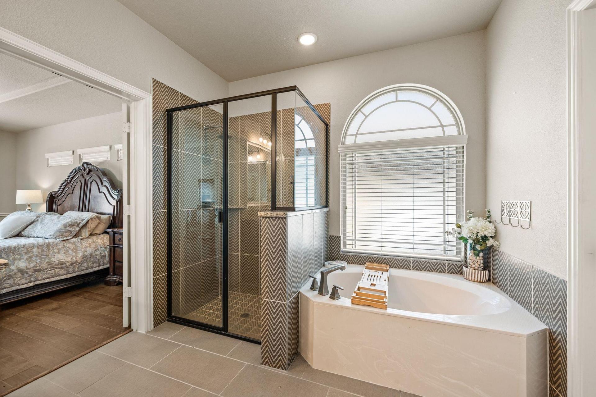Primary ensuite bathroom with dual vanities and separate shower at 4201 Rainwater Creek Way in Celina, Texas