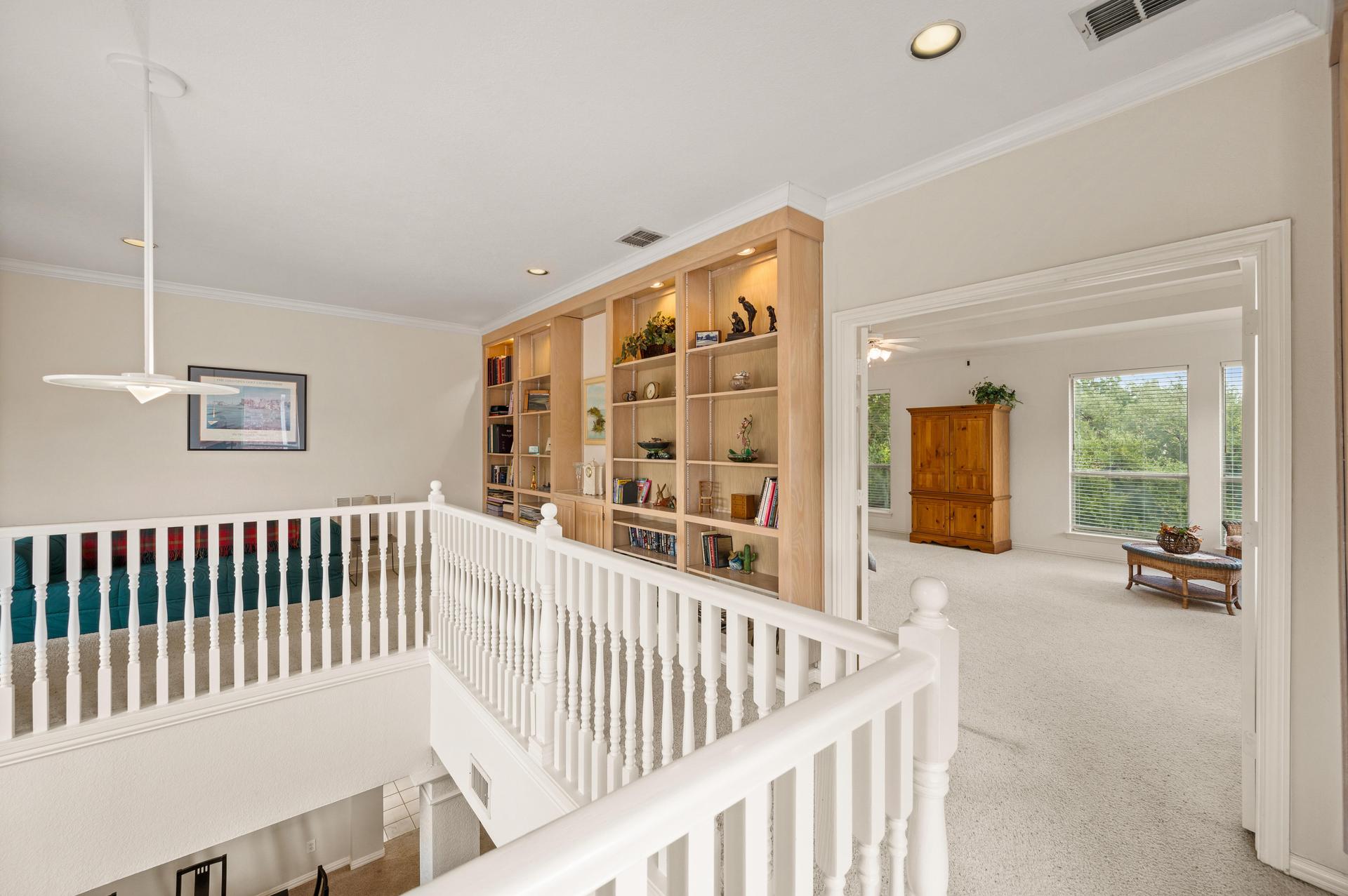 Upstairs landing overlooking the main living area at 7626 Lakecrest Circle