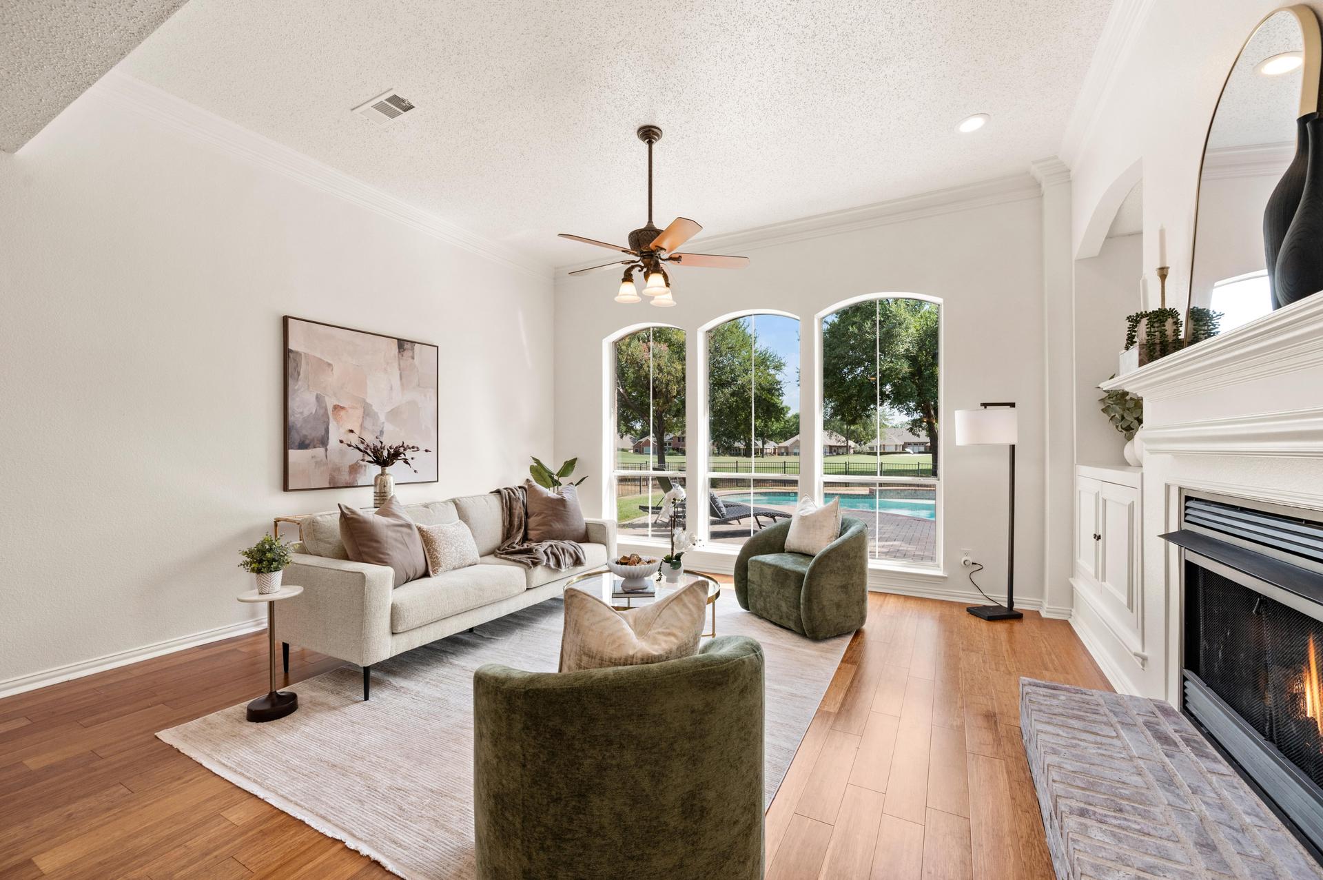 Living room with fireplace and pool views at 3628 Stone Creek Lane in North Fort Worth
