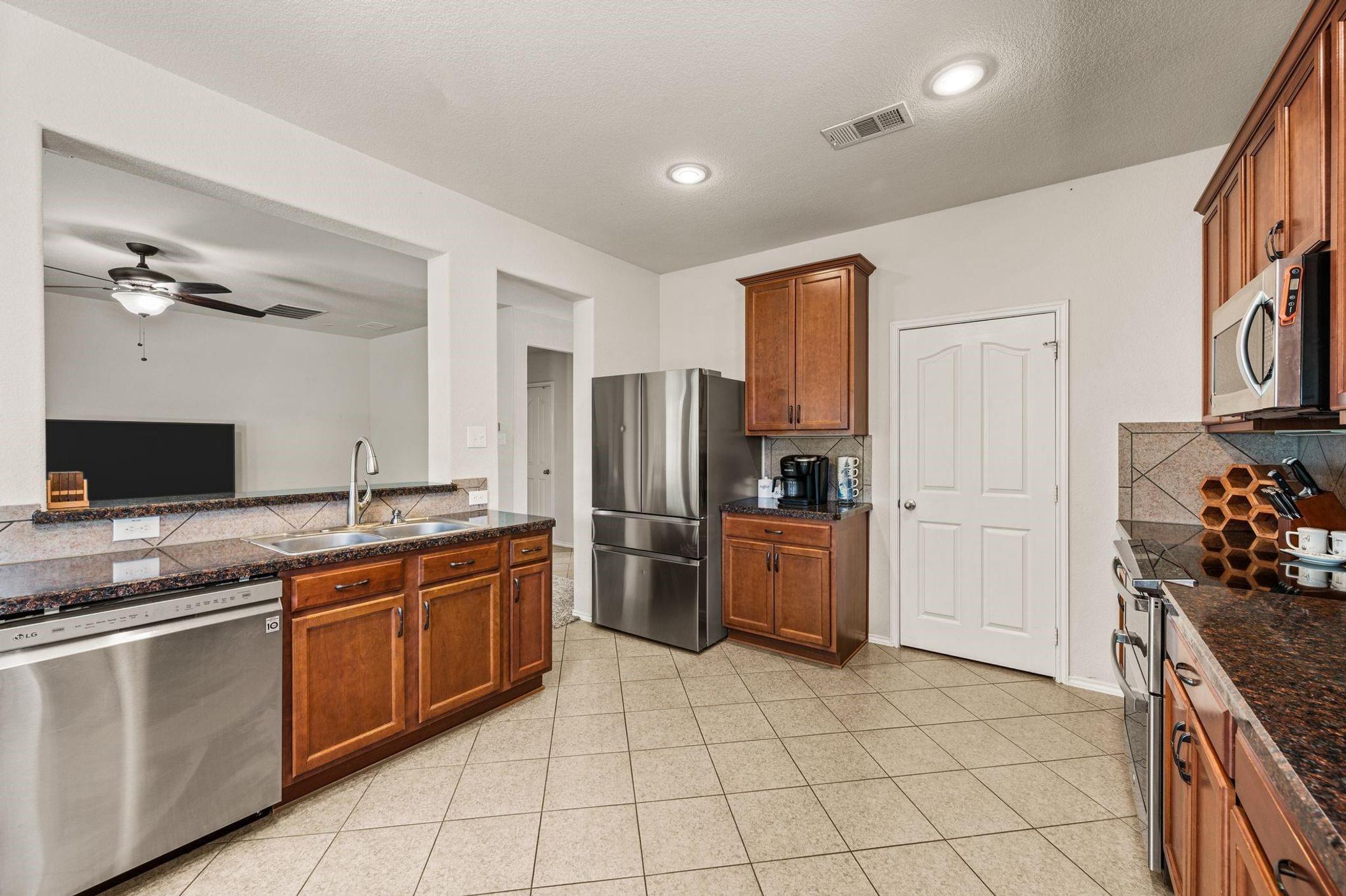 Open-concept kitchen in Fossil Hill Estates, North Fort Worth, featuring stainless steel appliances, abundant cabinet storage, and generous prep space.