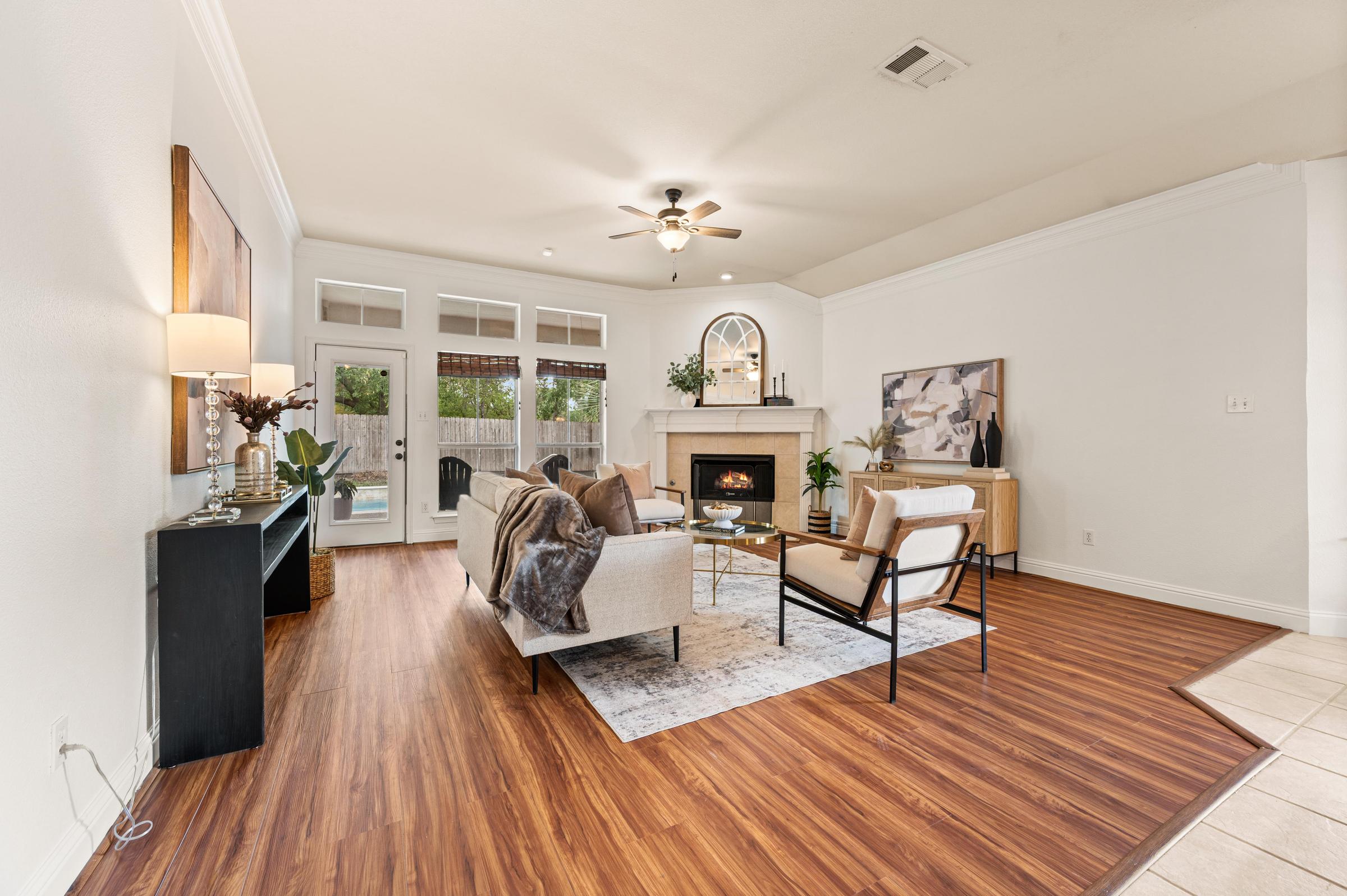 Living room with fireplace and views of the private pool at 7613 Woodhaven Drive in North Richland Hills, Texas